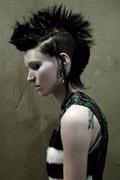 She is contemplating the next tattoo she gives.
