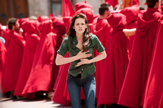 A team of monks politely looks away as Kristen Stewart realizes she has a flat tire in her implant