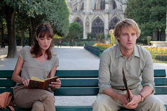 He looks pretty miserable for a dude sitting next to a beautiful girl in Paris.